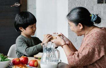 Grandmother and child sharing food