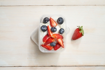 Small container of yoghurt with chopped fruit 